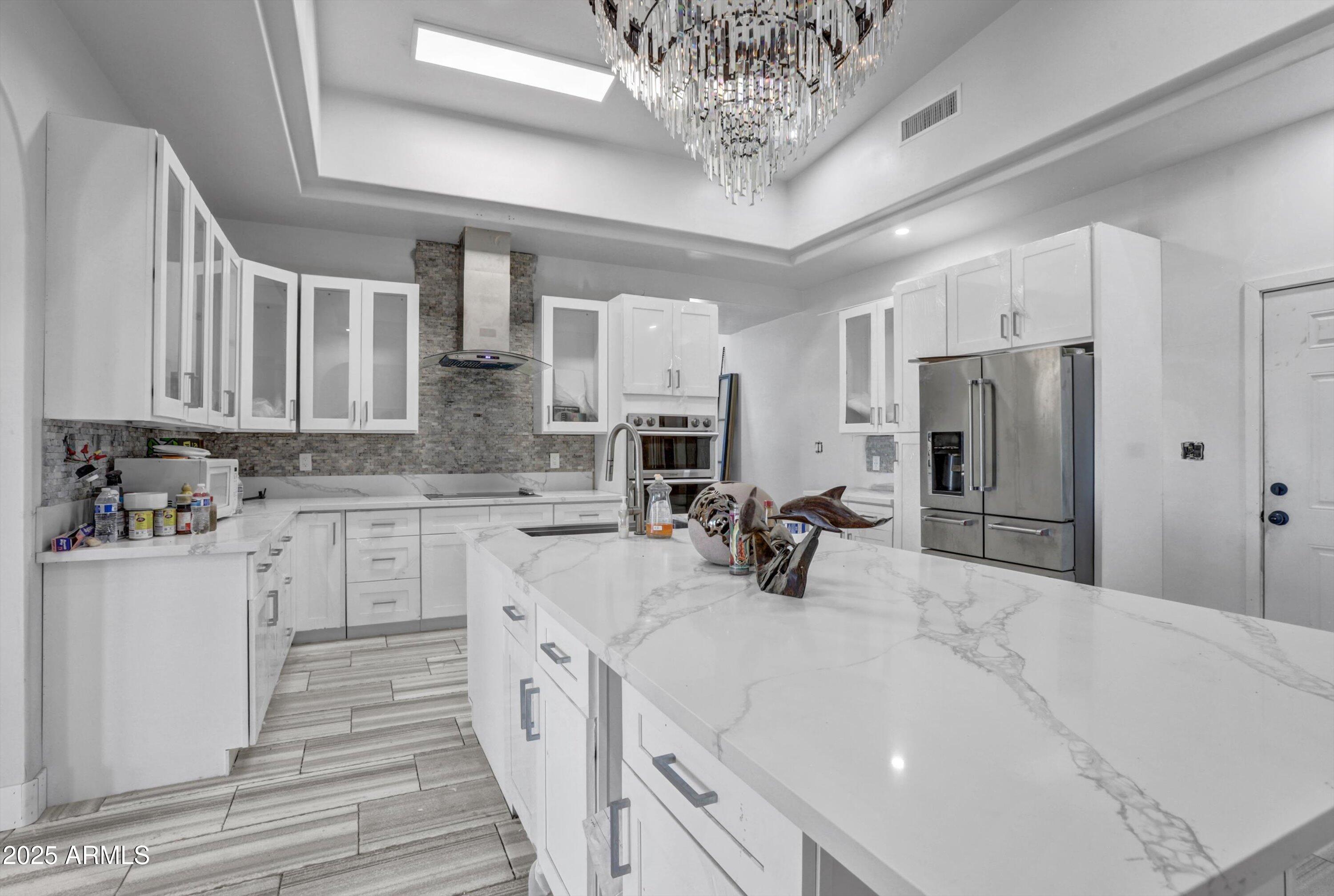 317 West Frontier Street Apache Junction, AZ 85120 - Photo 22 of 28 a kitchen with stainless steel appliances a refrigerator sink and cabinets