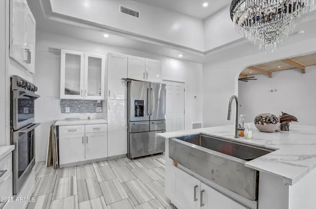 a kitchen with stainless steel appliances a sink stove and refrigerator