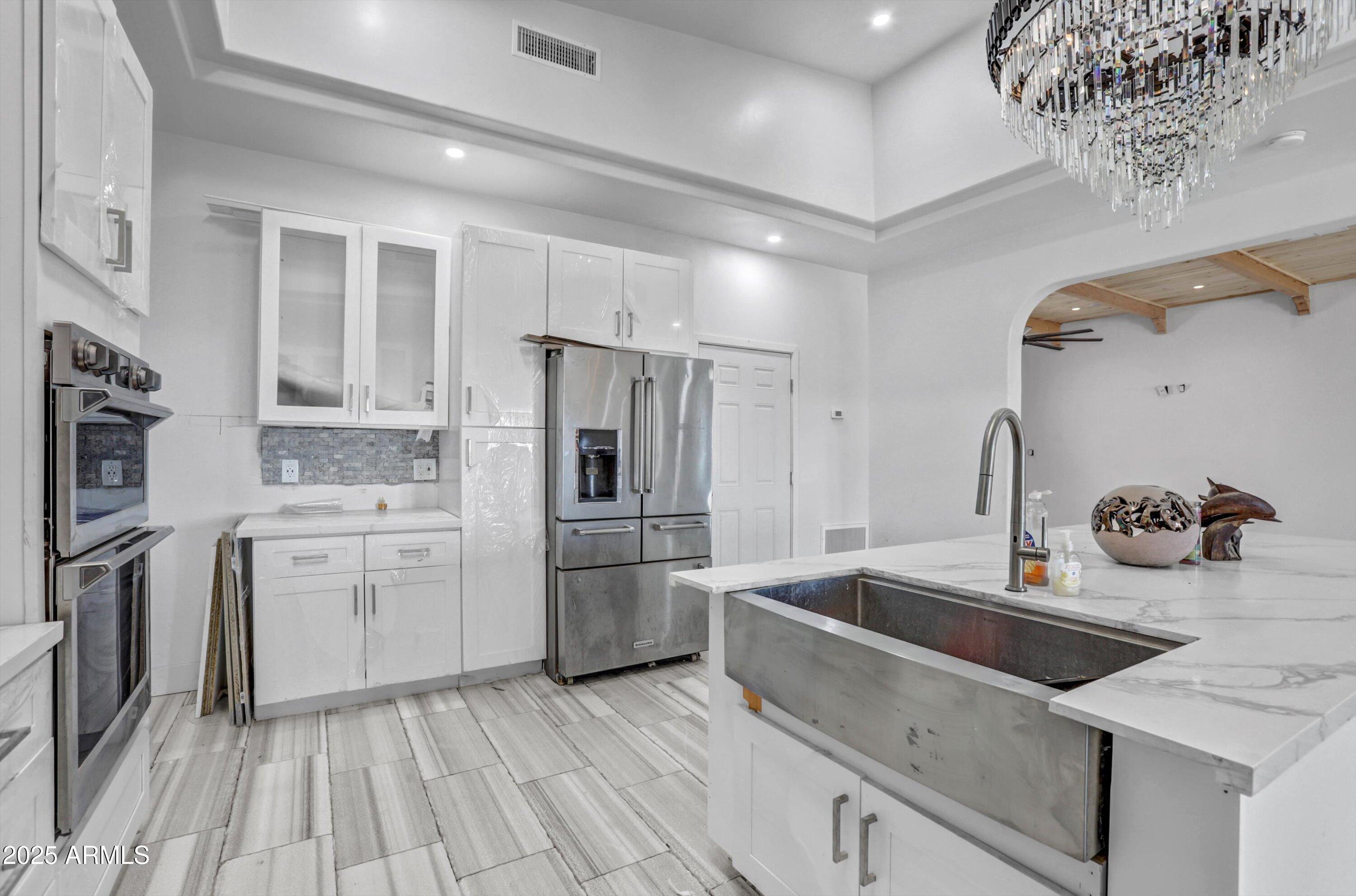 317 West Frontier Street Apache Junction, AZ 85120 - Photo 24 of 28 a kitchen with stainless steel appliances a sink stove and refrigerator