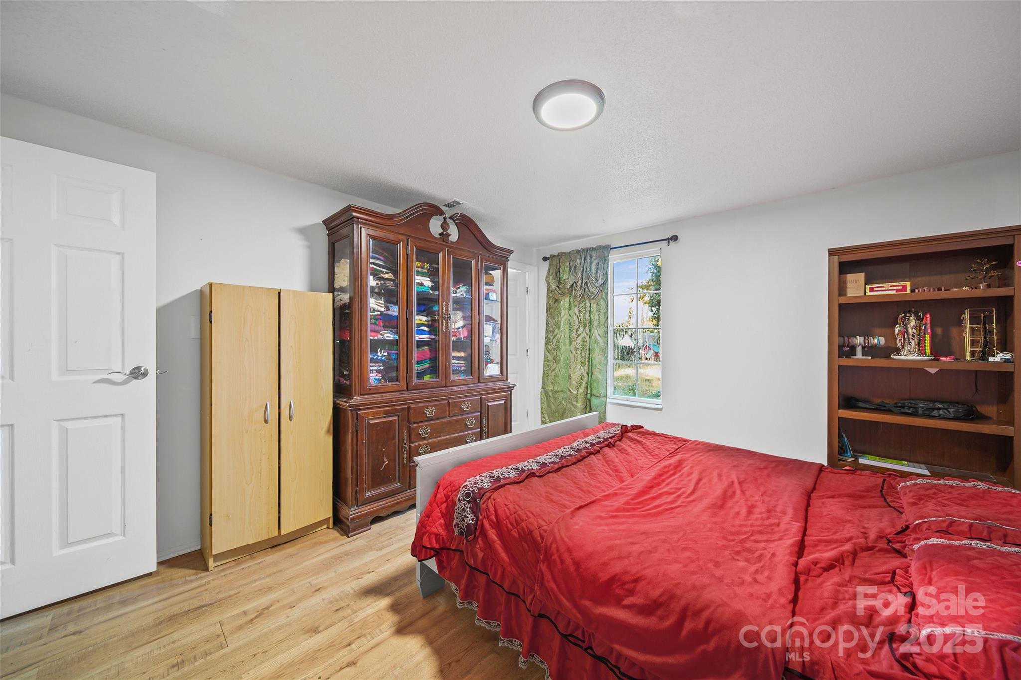 4823 Smokehollow Road Charlotte, NC 28227 - Photo 14 of 31 a bedroom with a large bed and a closet