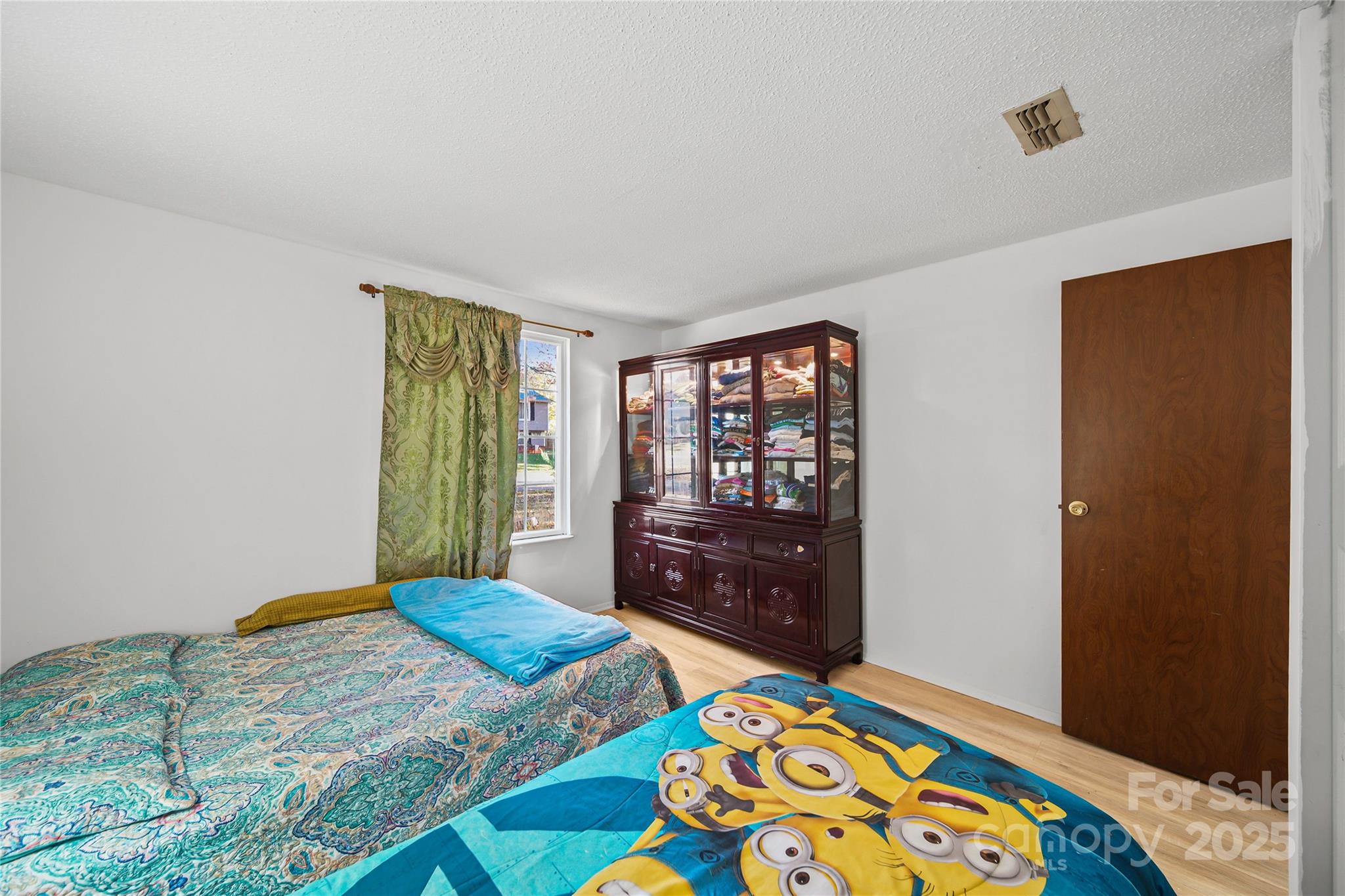 4823 Smokehollow Road Charlotte, NC 28227 - Photo 19 of 31 a bedroom with a bed and a dresser in it