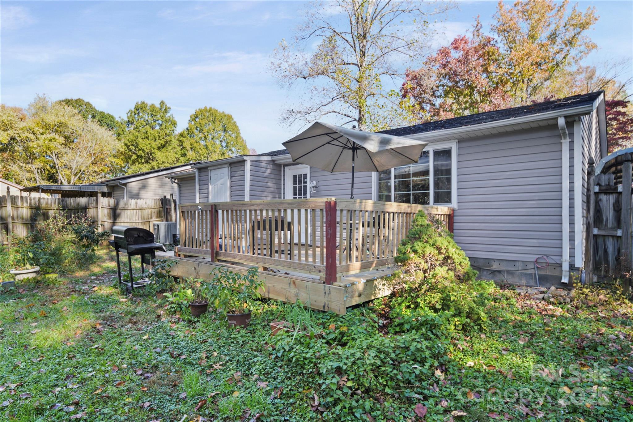 4823 Smokehollow Road Charlotte, NC 28227 - Photo 27 of 31 a view of a house with wooden fence and garden