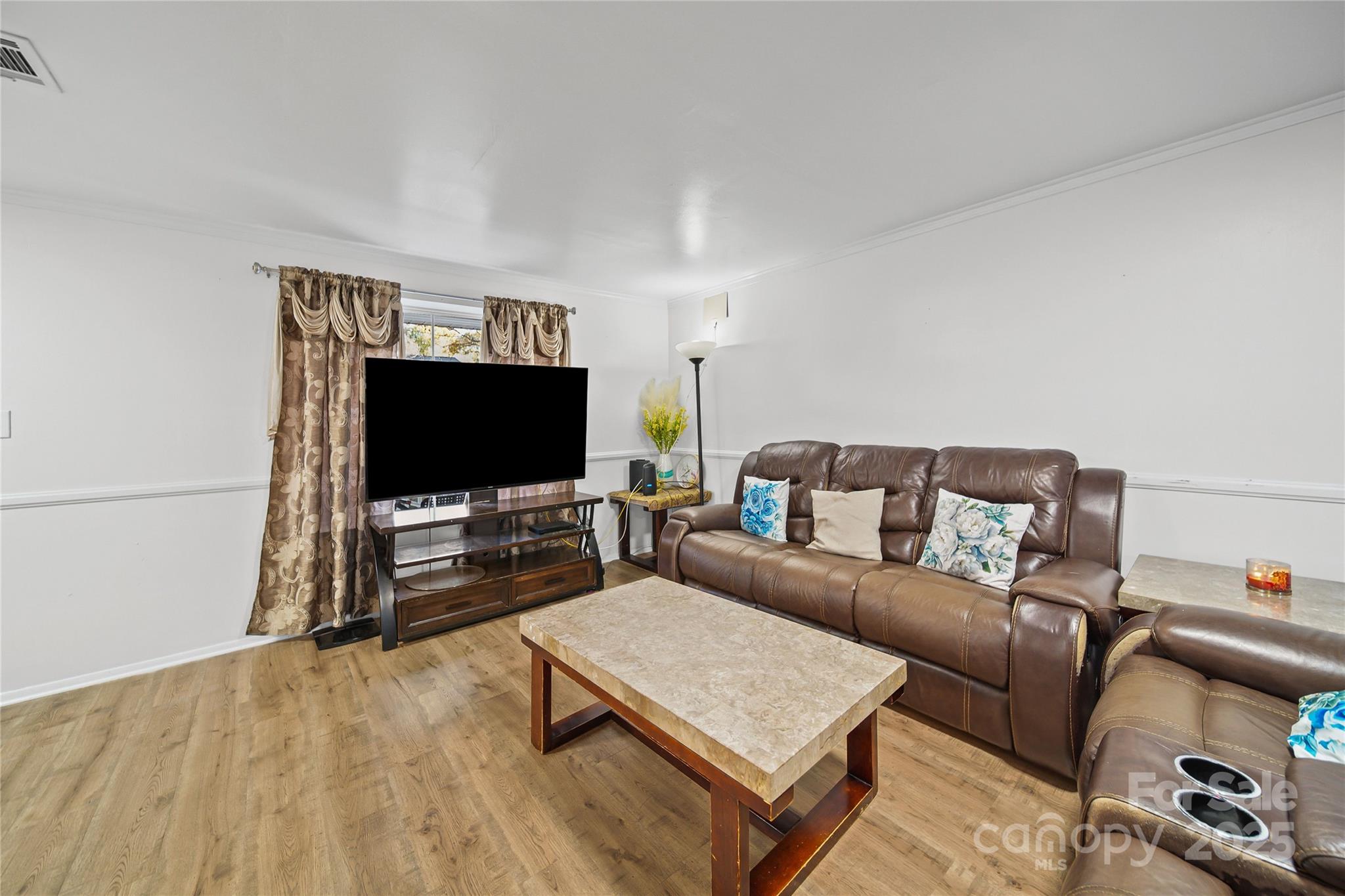 4823 Smokehollow Road Charlotte, NC 28227 - Photo 5 of 31 a living room with furniture and a flat screen tv