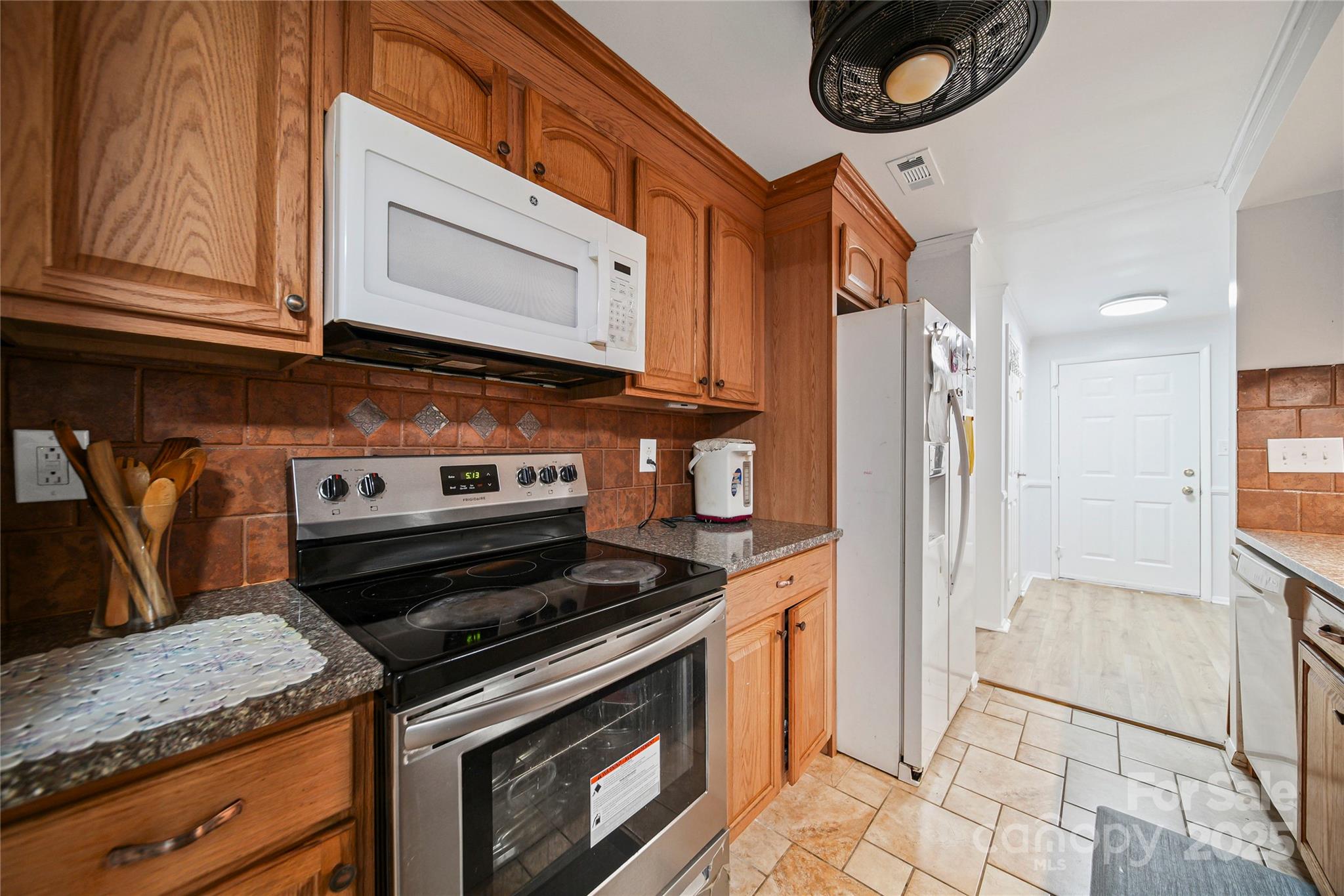 4823 Smokehollow Road Charlotte, NC 28227 - Photo 8 of 31 a kitchen with stainless steel appliances granite countertop a stove and a microwave
