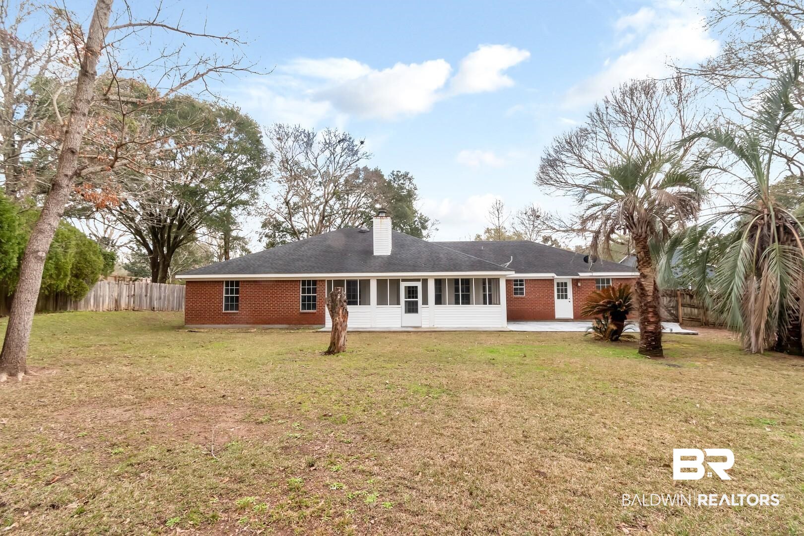 10006 Wedgefield Court Mobile, AL 36608 - Photo 1 of 34 Rear view of house with a chimney, fence, a lawn, and brick siding