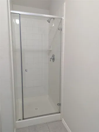 a bathroom with a glass shower door