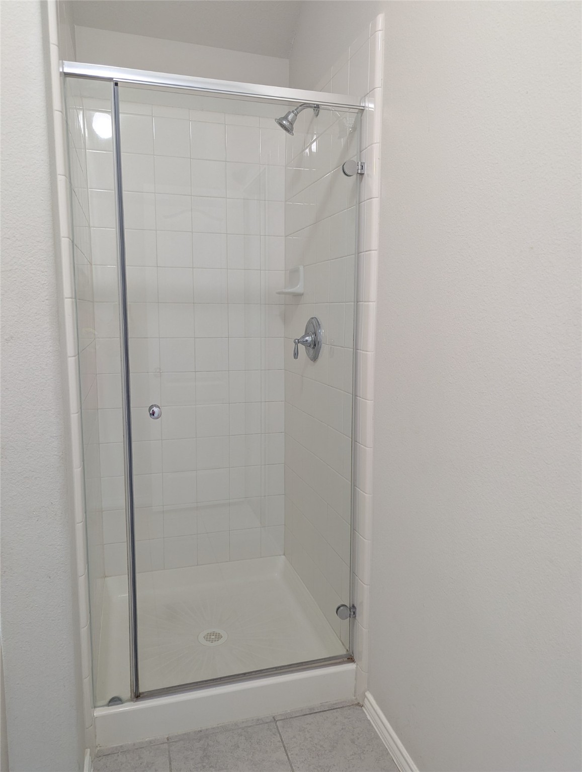 13319 Lansdown Street Rosharon, TX 77583 - Photo 12 of 22 a bathroom with a glass shower door