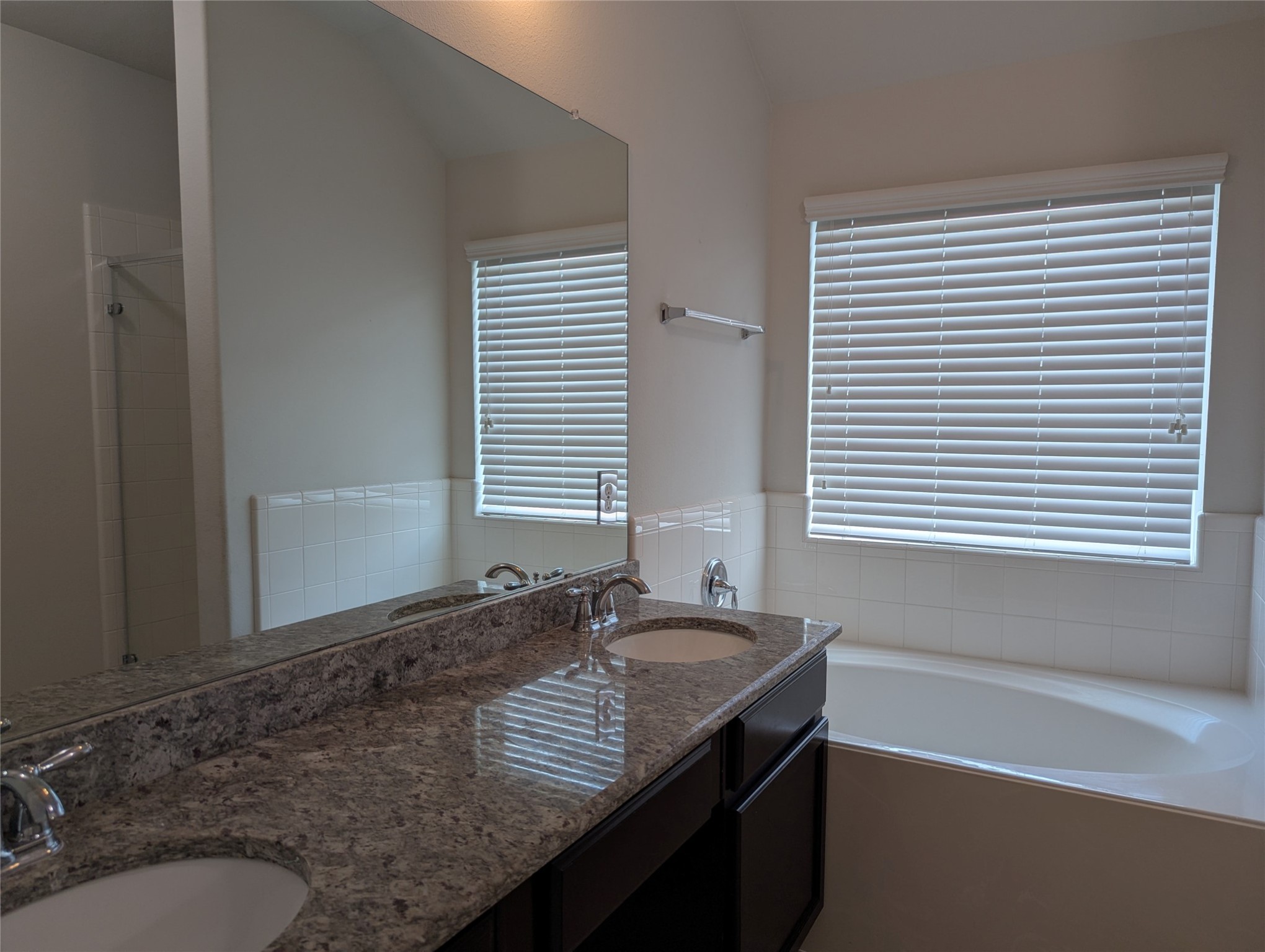 13319 Lansdown Street Rosharon, TX 77583 - Photo 14 of 22 a bathroom with a granite countertop sink and a window
