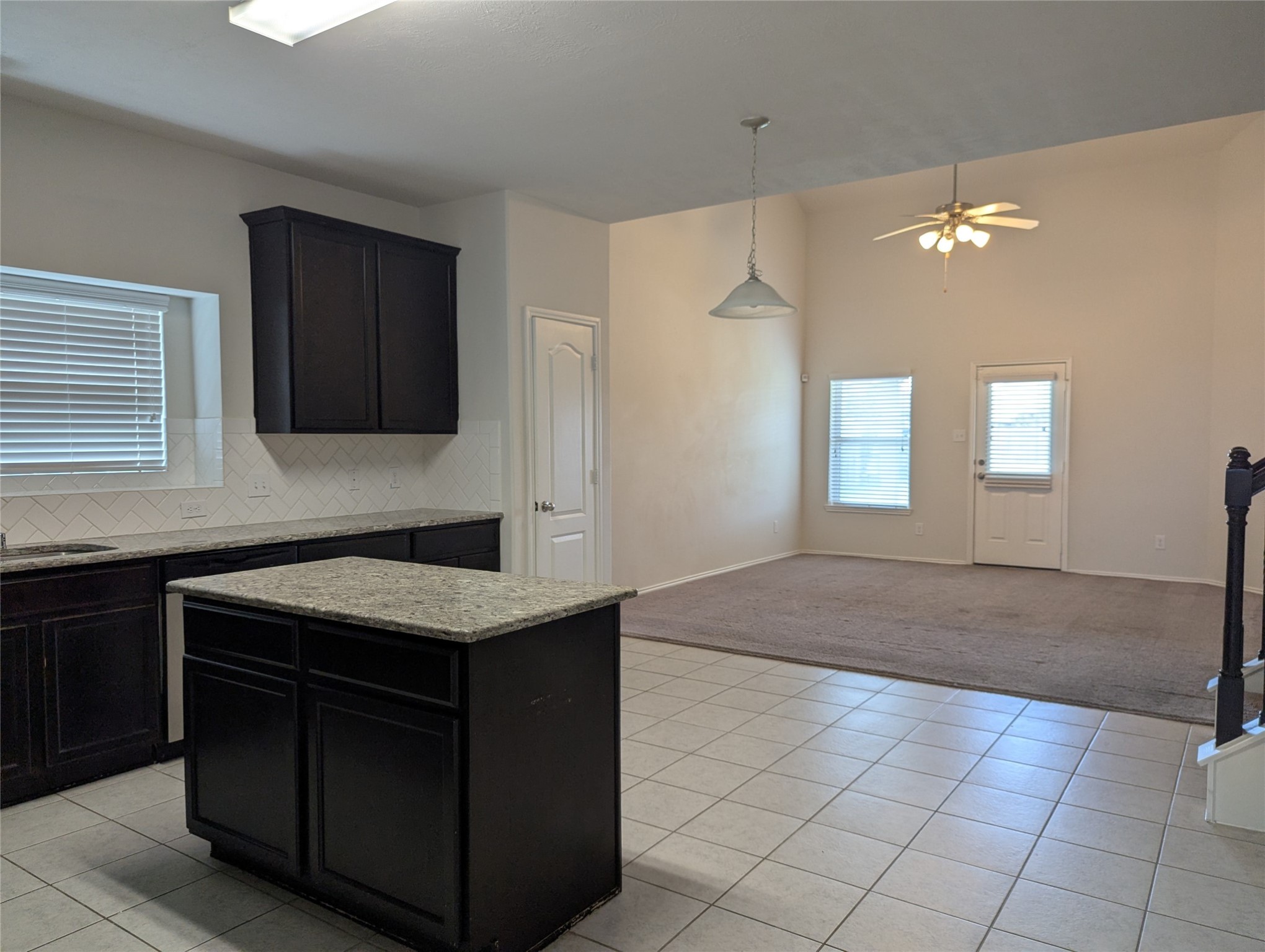 13319 Lansdown Street Rosharon, TX 77583 - Photo 4 of 22 a kitchen with a sink granite counter tops and a window