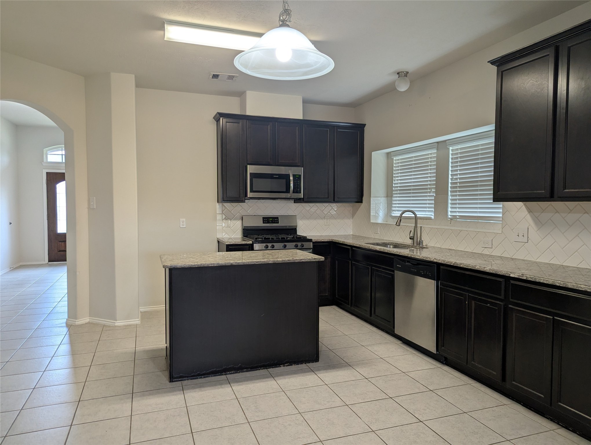 13319 Lansdown Street Rosharon, TX 77583 - Photo 8 of 22 a kitchen with stainless steel appliances granite countertop a refrigerator and a sink