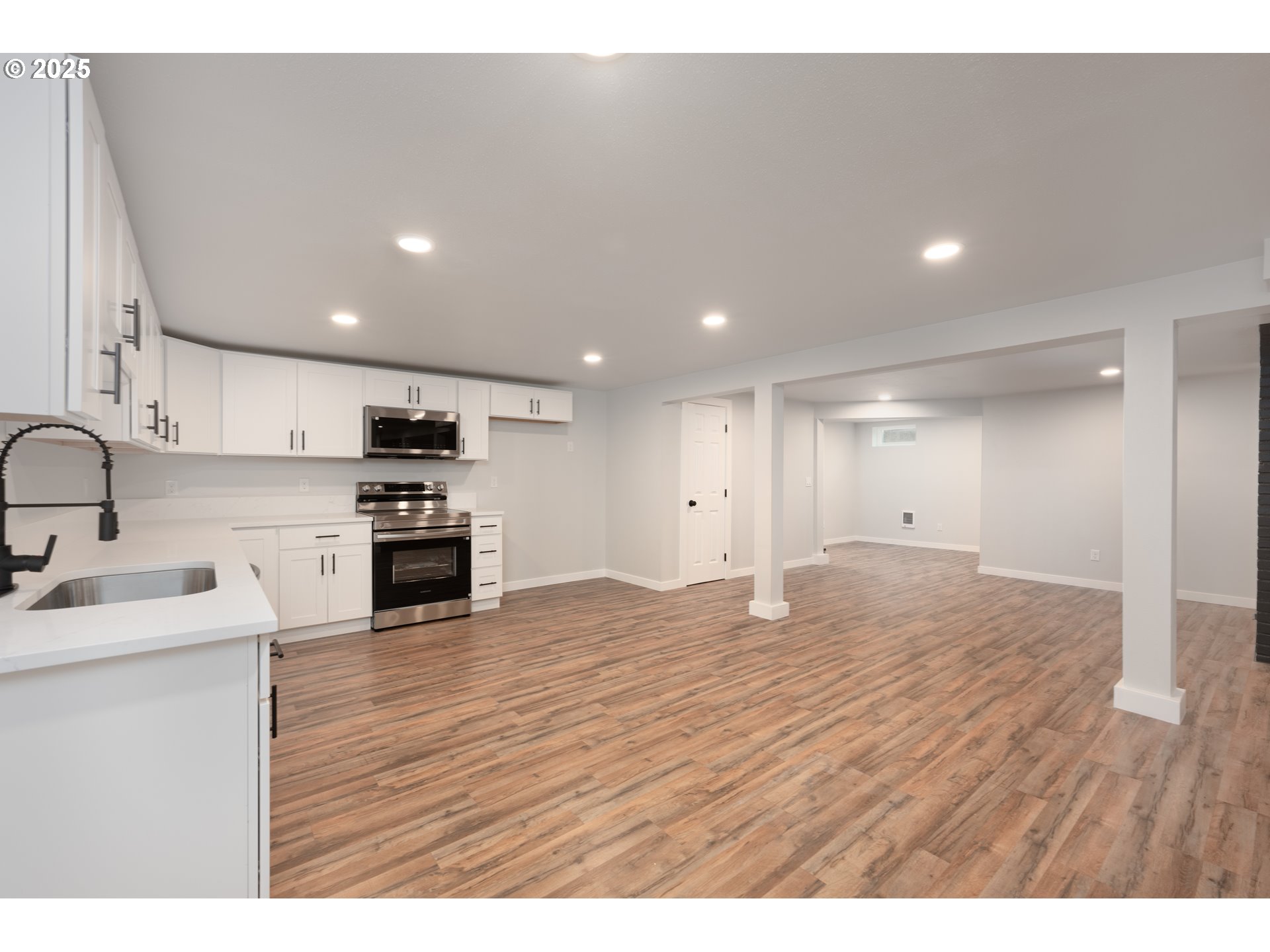 5775 Southeast Cesar Estrada Chavez Boulevard Portland, OR 97202 - Photo 28 of 43 a kitchen with stainless steel appliances granite countertop a sink and cabinets