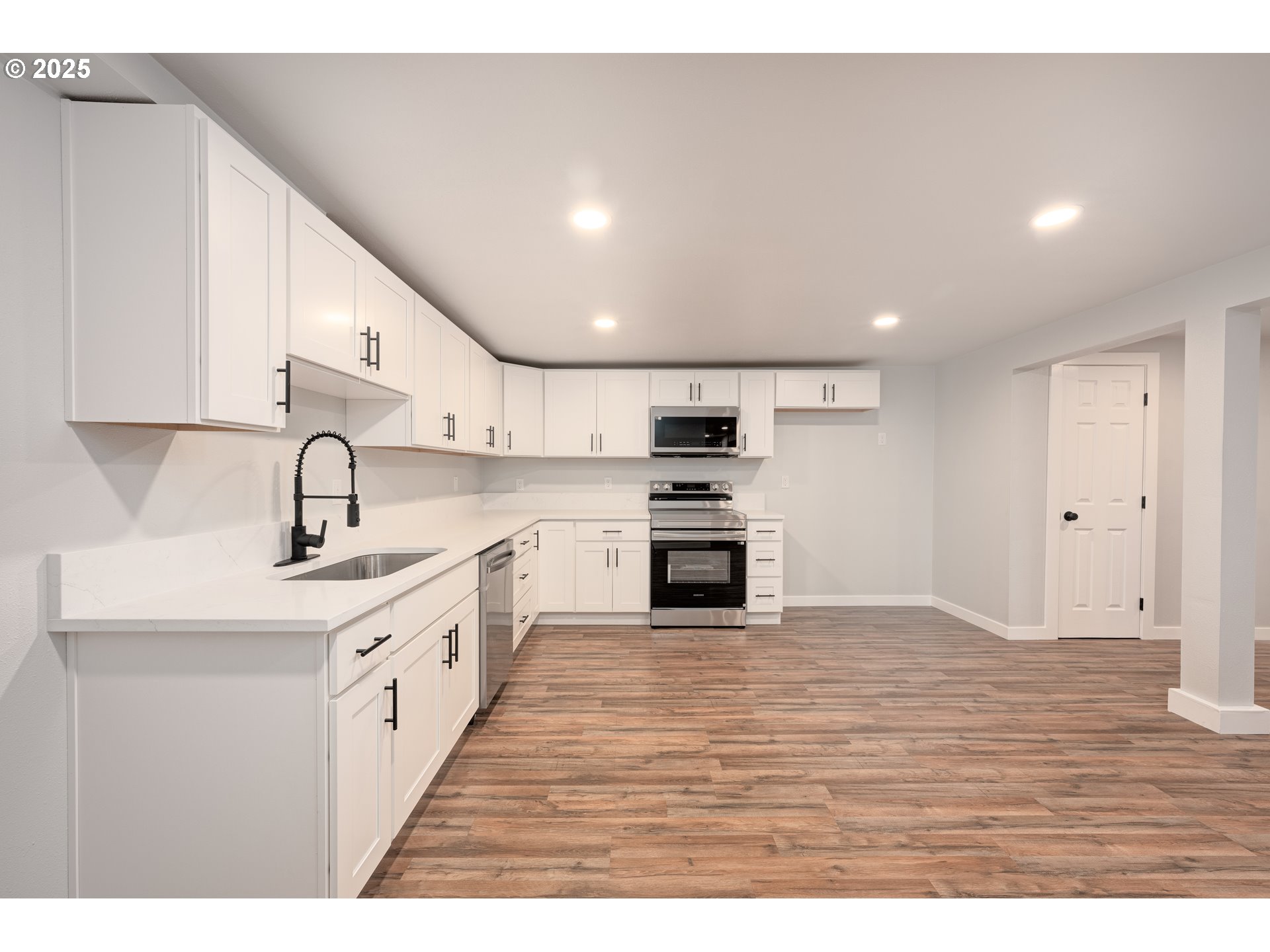 5775 Southeast Cesar Estrada Chavez Boulevard Portland, OR 97202 - Photo 29 of 43 a kitchen with stainless steel appliances granite countertop a sink and cabinets