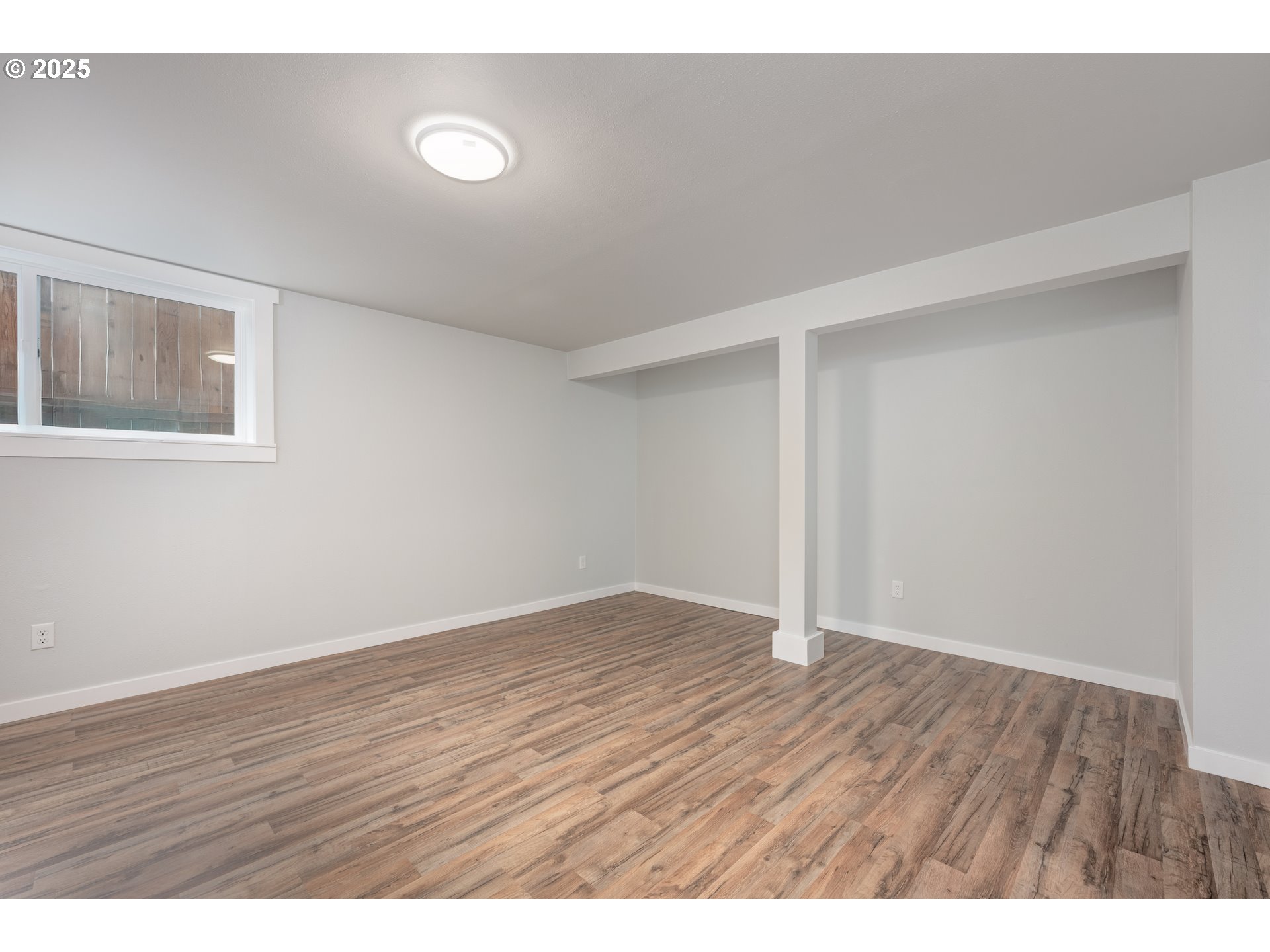 5775 Southeast Cesar Estrada Chavez Boulevard Portland, OR 97202 - Photo 32 of 43 a view of an empty room with wooden floor