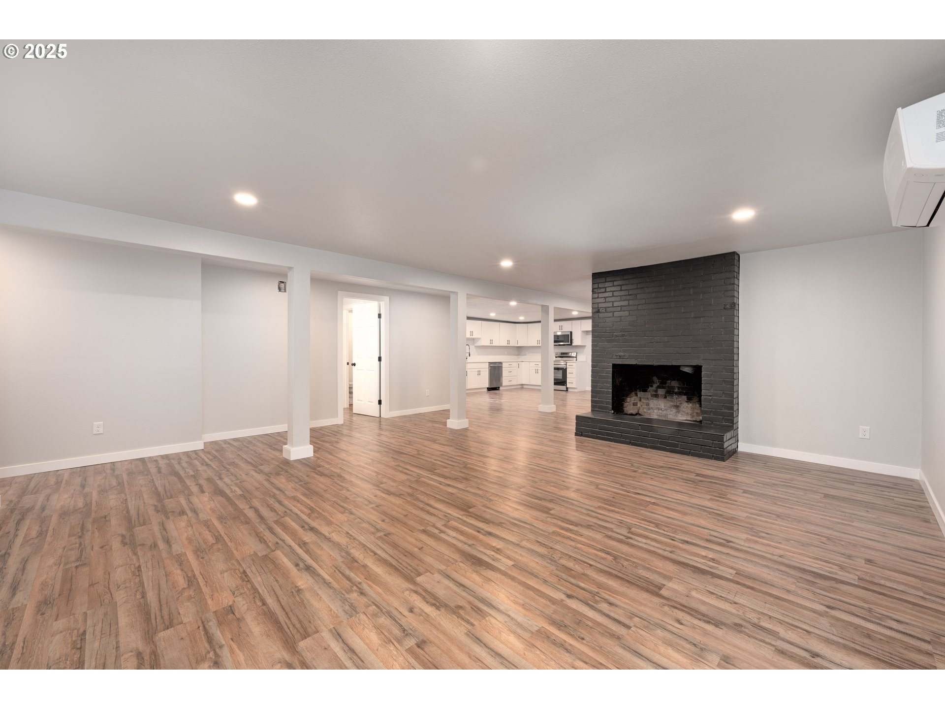 5775 Southeast Cesar Estrada Chavez Boulevard Portland, OR 97202 - Photo 38 of 43 a view of empty room with wooden floor and fireplace