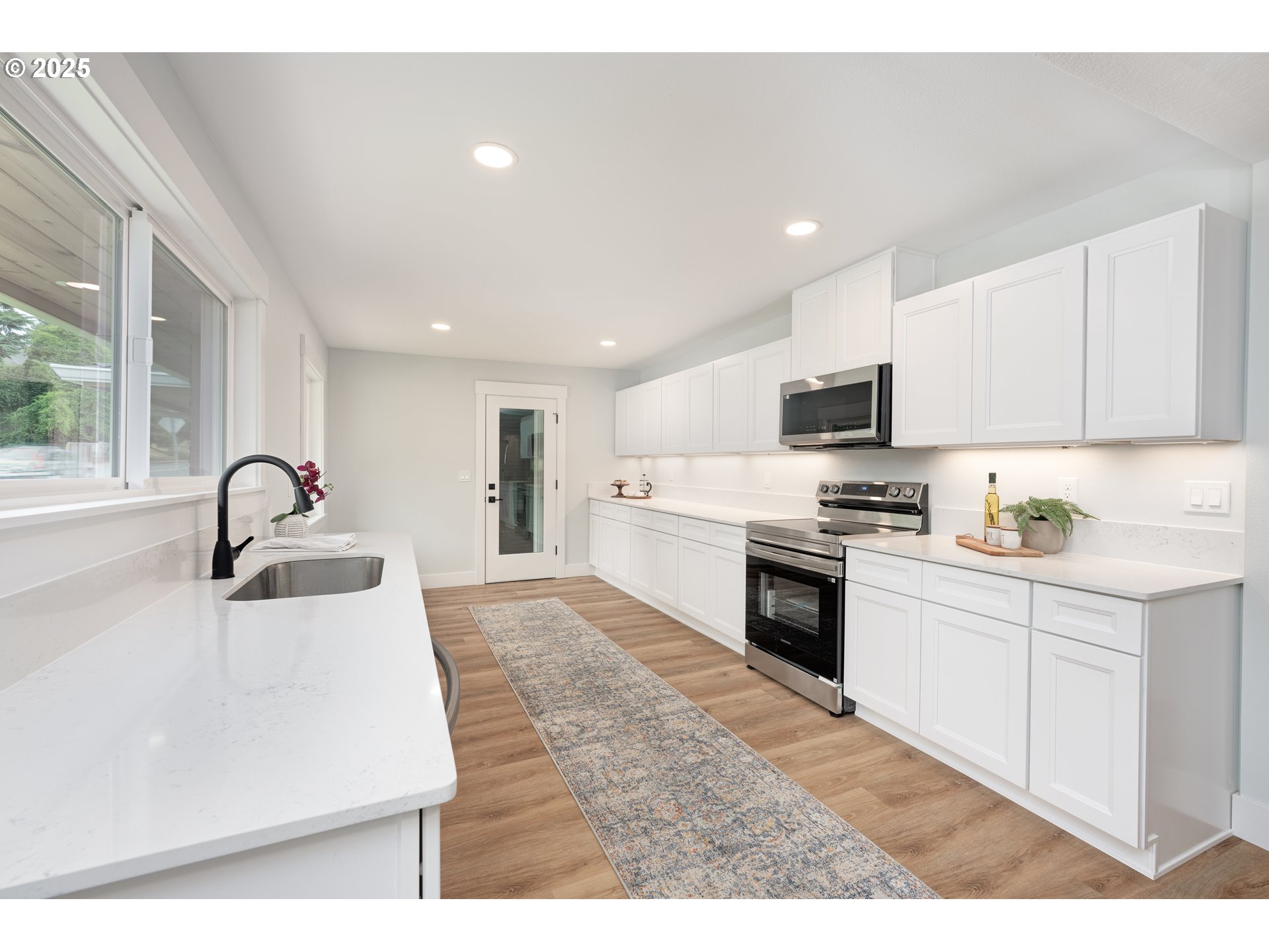 5775 Southeast Cesar Estrada Chavez Boulevard Portland, OR 97202 - Photo 4 of 43 a kitchen with stainless steel appliances kitchen island a sink a stove and cabinets