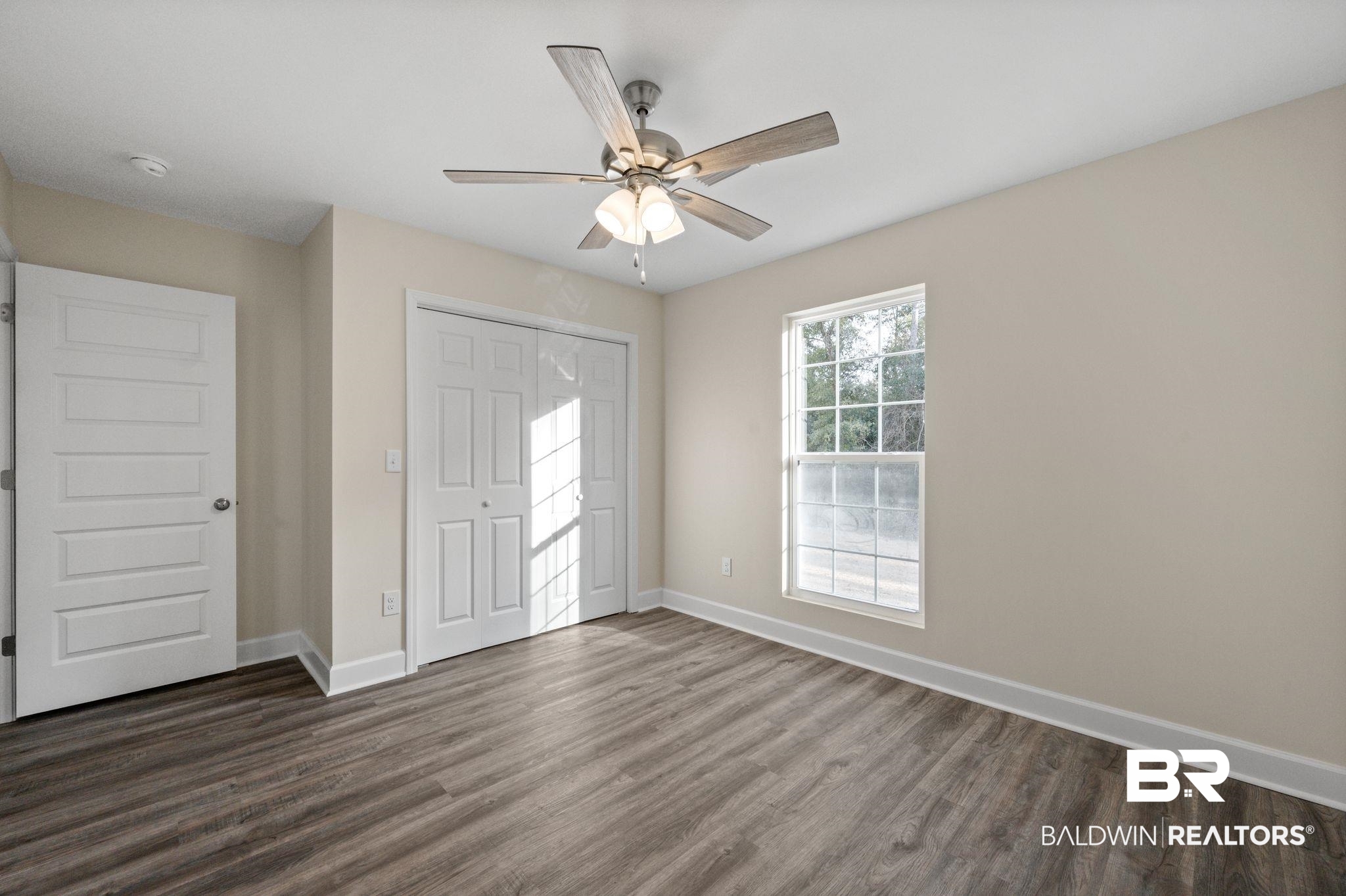 1473 Pollard Road Daphne, AL 36526 - Photo 23 of 32 Unfurnished bedroom featuring ceiling fan, dark hardwood / wood-style floors, and a closet