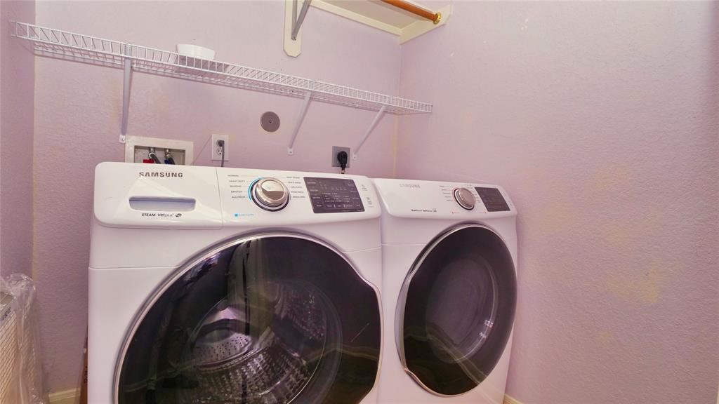 10235 Riderdale Park Lane Houston, TX 77070 - Photo 13 of 16 a utility room with dryer and washer