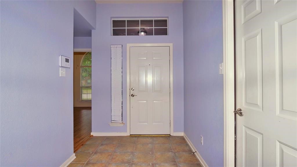 10235 Riderdale Park Lane Houston, TX 77070 - Photo 3 of 16 a view of a hallway with wooden door