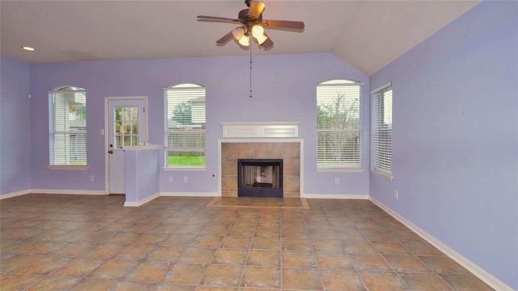 10235 Riderdale Park Lane Houston, TX 77070 - Photo 5 of 16 a view of livingroom with window fireplace and a chandelier fan