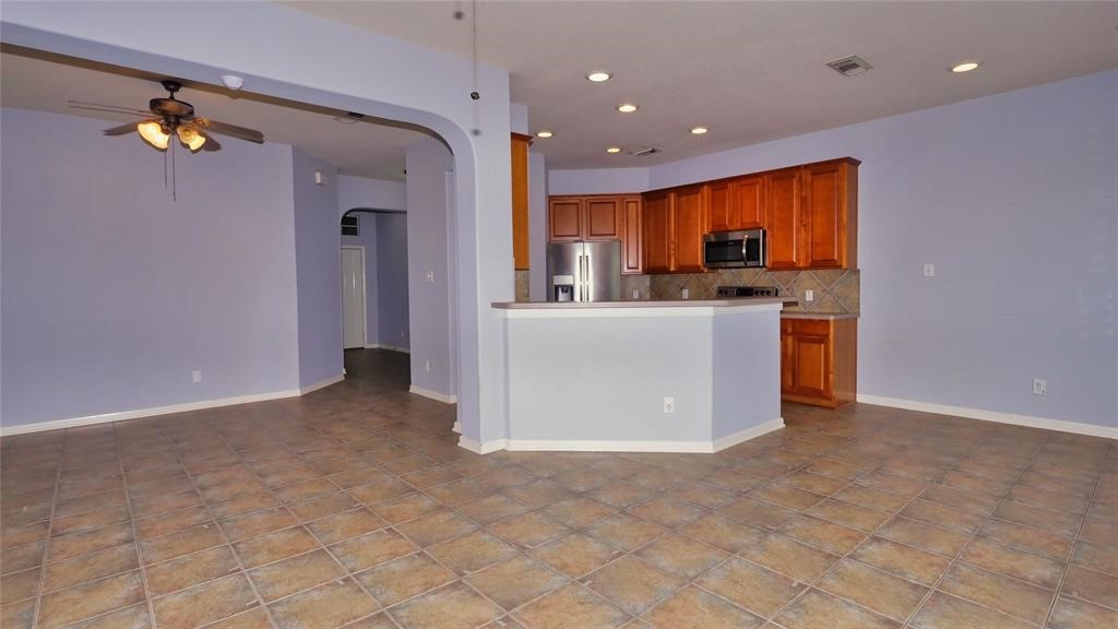 10235 Riderdale Park Lane Houston, TX 77070 - Photo 6 of 16 a view of kitchen with stainless steel appliances a refrigerator and a stove