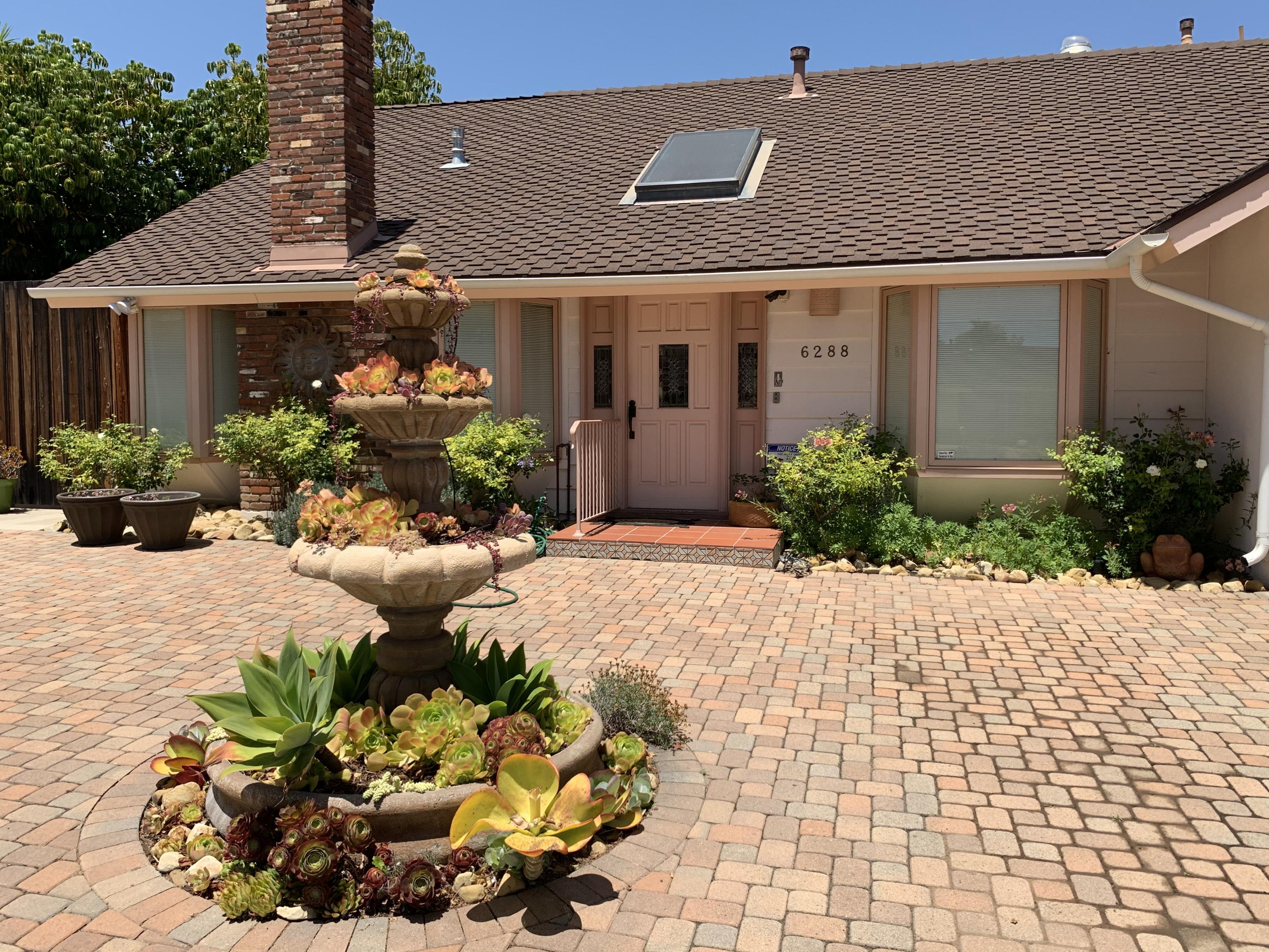 6288 Muirfield Drive Goleta, CA 93117 - Photo 26 of 26 a front view of a house with a yard and a garden