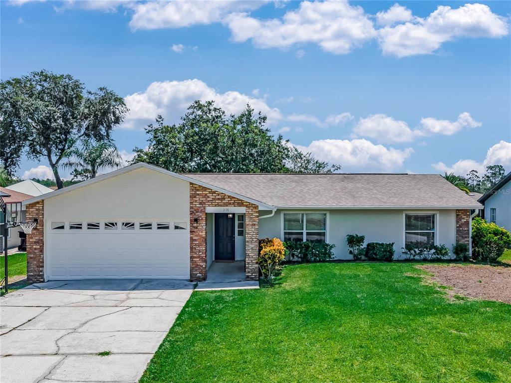 1131 Anne Elisa Circle St. Cloud, FL 34772 - Photo 1 of 1 a front view of a house with a garden and outdoor seating
