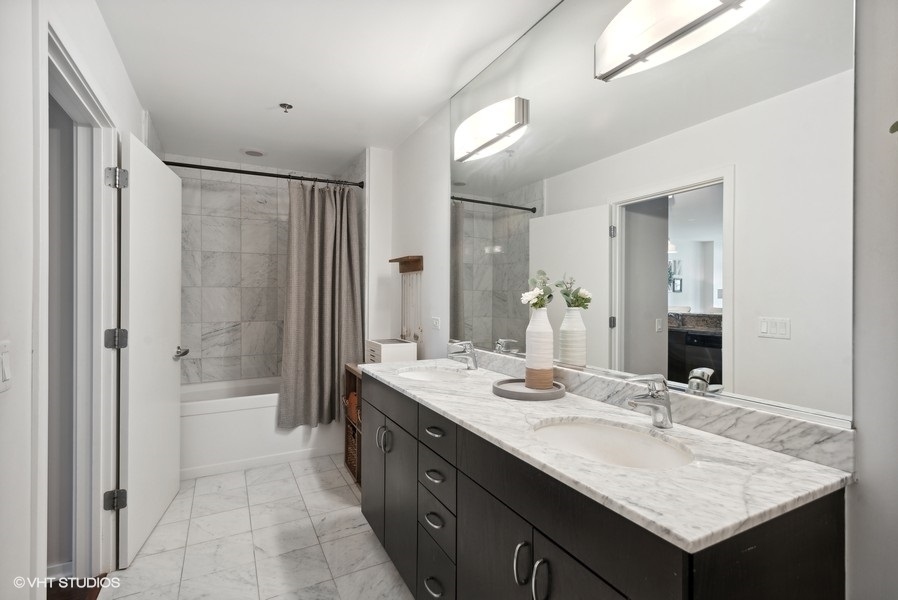 123 South Green Street, Unit 805B Chicago, IL 60607 - Photo 11 of 18 a bathroom with a granite countertop sink and a mirror