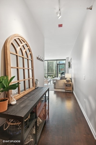 123 South Green Street, Unit 805B Chicago, IL 60607 - Photo 2 of 18 a living room with furniture and a potted plant