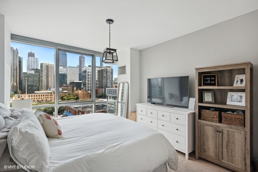 123 South Green Street, Unit 805B Chicago, IL 60607 - Photo 10 of 18 a bedroom with a bed and a flat screen tv