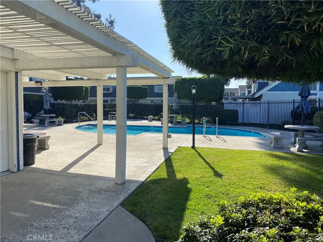 a swimming pool with patio outdoor seating and yard