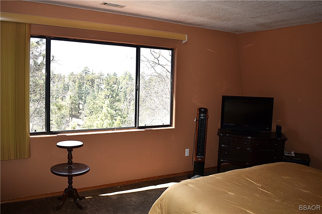 442 Inyo Avenue Sugarloaf, CA 92386 - Photo 20 of 36 a bedroom with a bed and a window