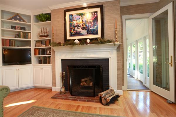 63 Sheffield Road Boxford, MA 01921 - Photo 8 of 30 a living room with a fireplace and a flat screen tv
