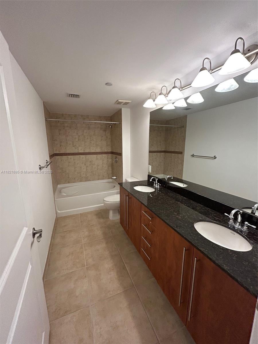 Kendall Miami, FL 33156 - Photo 8 of 16 a bathroom with a double vanity sink a mirror and shower
