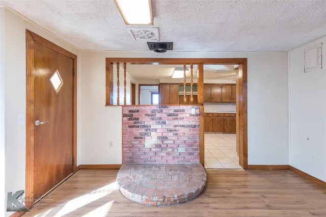 a view of a livingroom with wooden floor and a large window