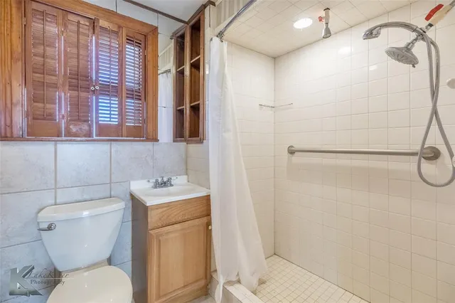 a bathroom with a toilet sink and shower