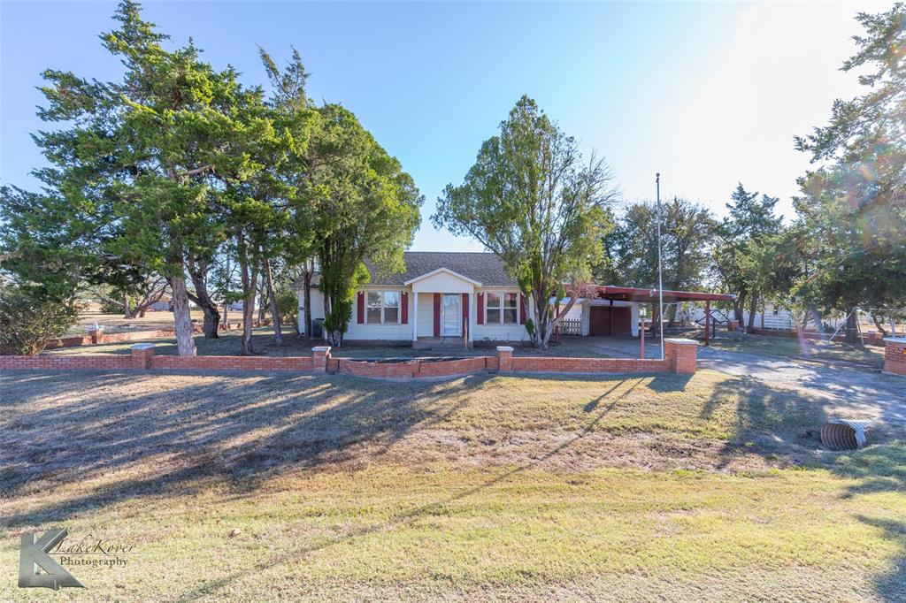 405 South Hinton Street Benjamin, TX 79505 - Photo 2 of 40 View of front of property featuring a carport, a front lawn, and a porch