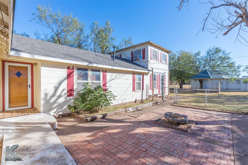 405 South Hinton Street Benjamin, TX 79505 - Photo 23 of 40 View of front of property featuring a shingled roof, a patio, and a fire pit
