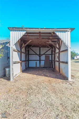 a front view of a house with a tree