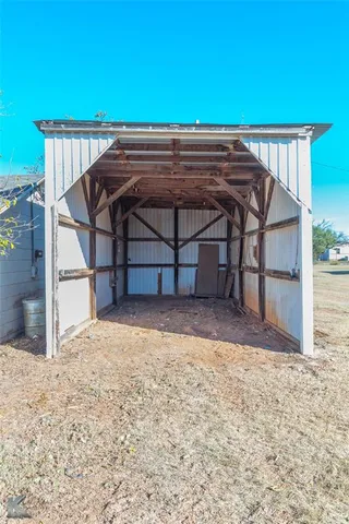 a front view of a house with a tree