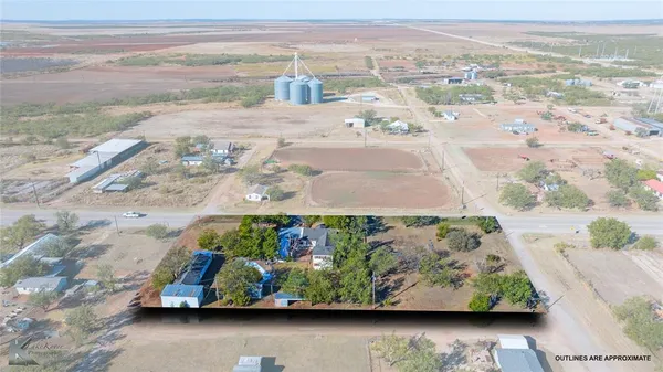 an aerial view of a house with yard basket ball court and outdoor seating