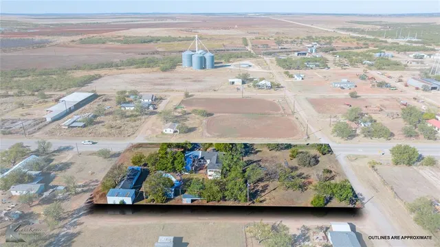 an aerial view of a house with yard basket ball court and outdoor seating