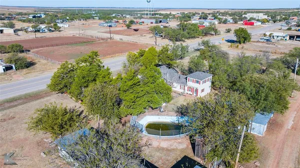 an aerial view of a house with a yard and lake view