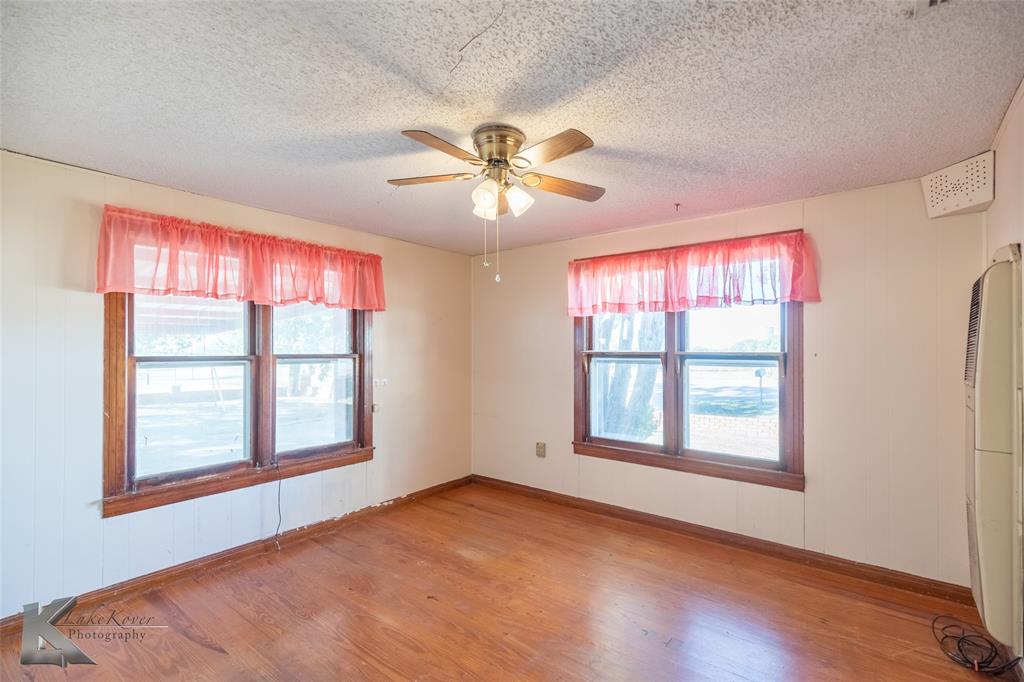 405 South Hinton Street Benjamin, TX 79505 - Photo 5 of 40 Empty room with light wood-style floors, ceiling fan, and a textured ceiling