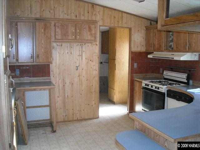 17290 Sunbird Lane Reno, NV 89508 - Photo 5 of 9 a kitchen with granite countertop a refrigerator and a stove