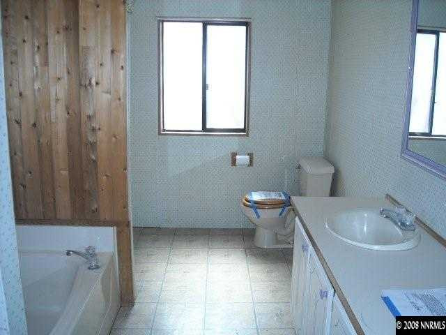 17290 Sunbird Lane Reno, NV 89508 - Photo 8 of 9 a bathroom with a sink toilet and shower