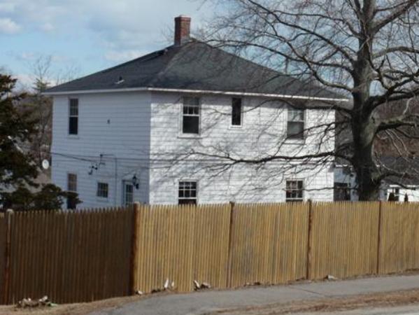 55 Marion Road Scituate, MA 02066 - Photo 13 of 16 a front view of a house with a wooden fence