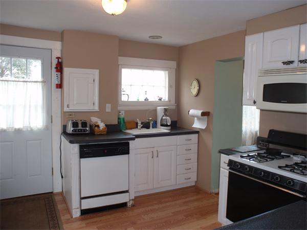 55 Marion Road Scituate, MA 02066 - Photo 7 of 16 a kitchen with stainless steel appliances a stove a sink and a microwave
