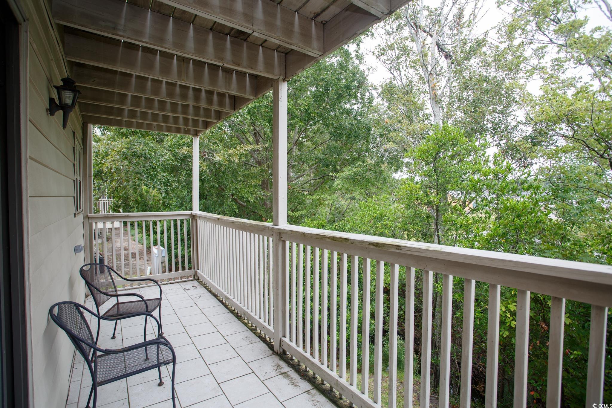 1356 Glenns Bay Road, Unit 201B Surfside Beach, SC 29575 - Photo 11 of 37 Balcony featuring view of wooded area