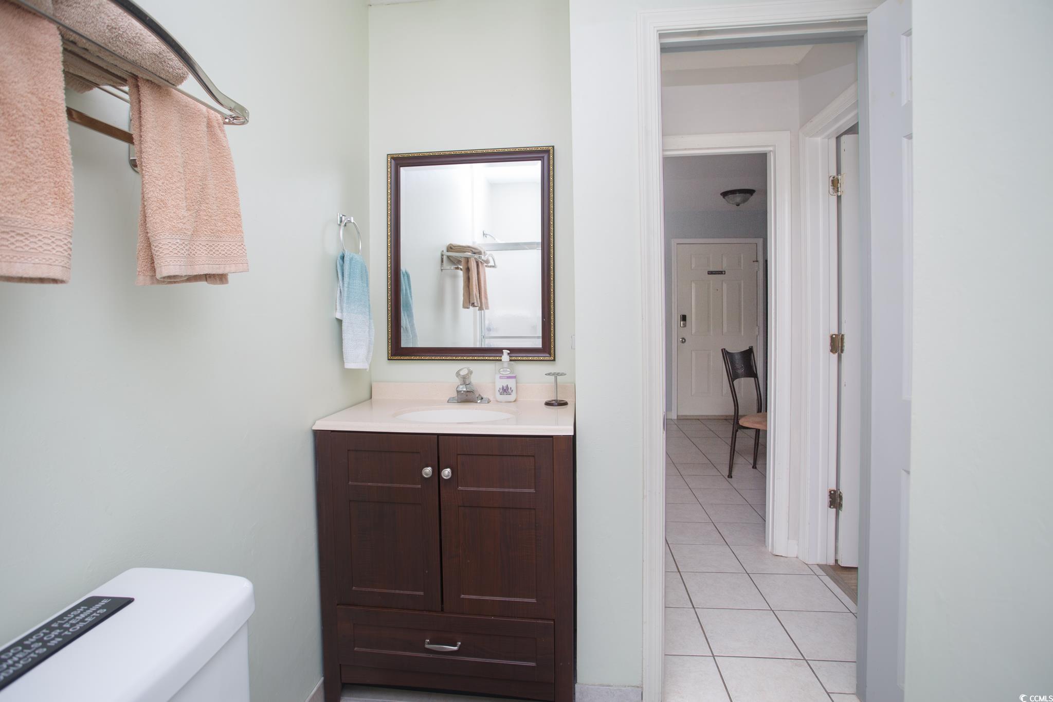 1356 Glenns Bay Road, Unit 201B Surfside Beach, SC 29575 - Photo 14 of 37 Half bathroom with vanity and light tile patterned