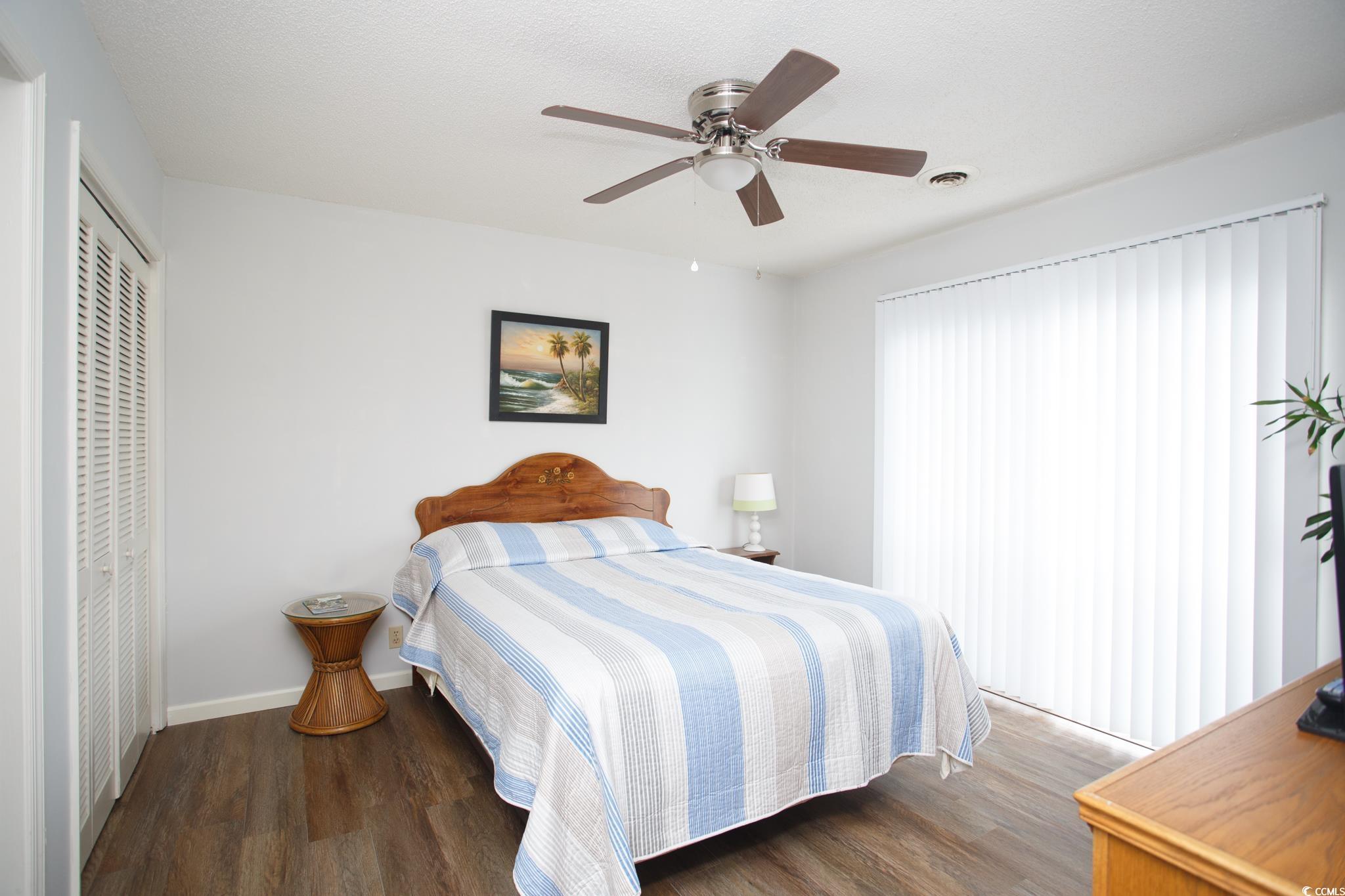 1356 Glenns Bay Road, Unit 201B Surfside Beach, SC 29575 - Photo 15 of 37 Bedroom featuring a closet, dark wood-type floorin
